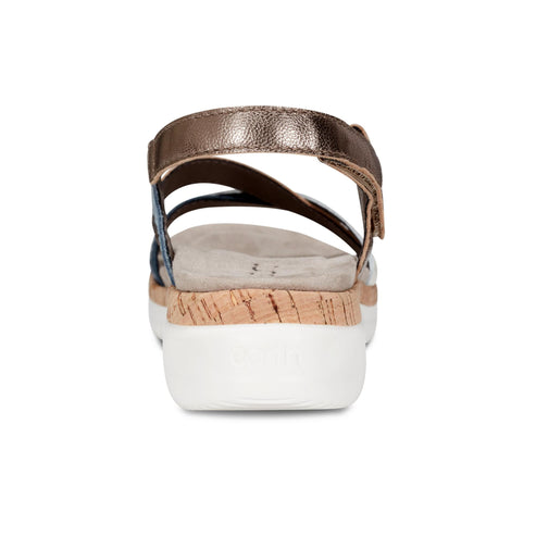 Back view of sandal with metallic bronze, blue, and cork straps on a white platform.