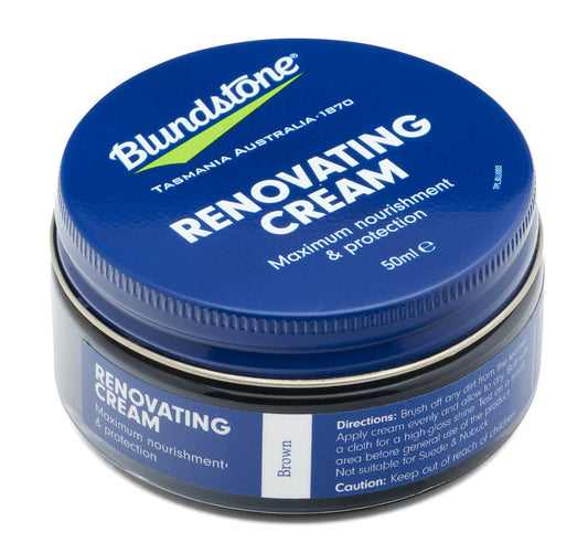 Circular tin of renovating cream for leather footwear, with a dark blue lid.