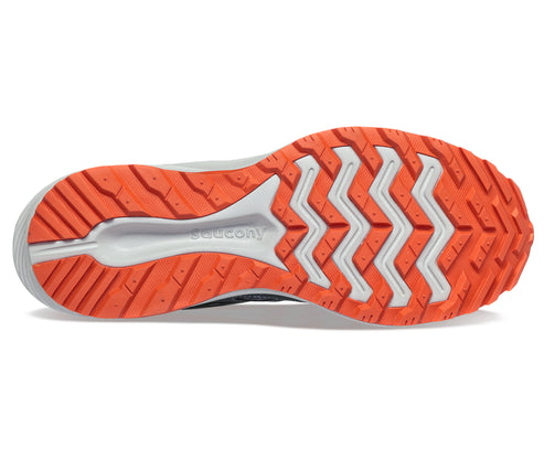 Bottom view of a shoe with an orange outsole featuring a geometric zig zag tread pattern.