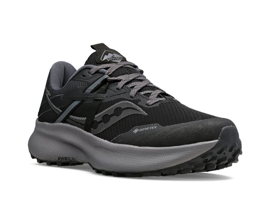Black and grey running shoe with lug sole and Gore-Tex marking.