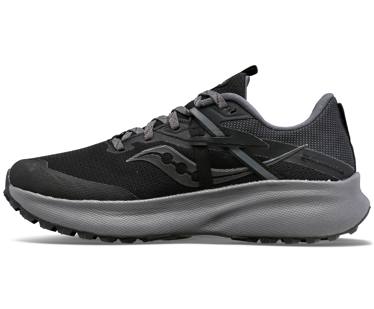 A black and gray running shoe with a thick gray sole, a black mesh upper, and black Saucony logo on the side.