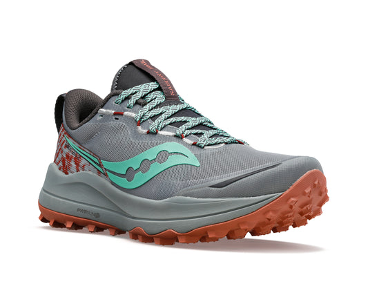 A gray running shoe with green logo and orange sole.