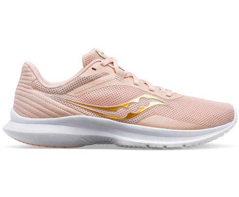 A pink running shoe with gold logo and a white sole.