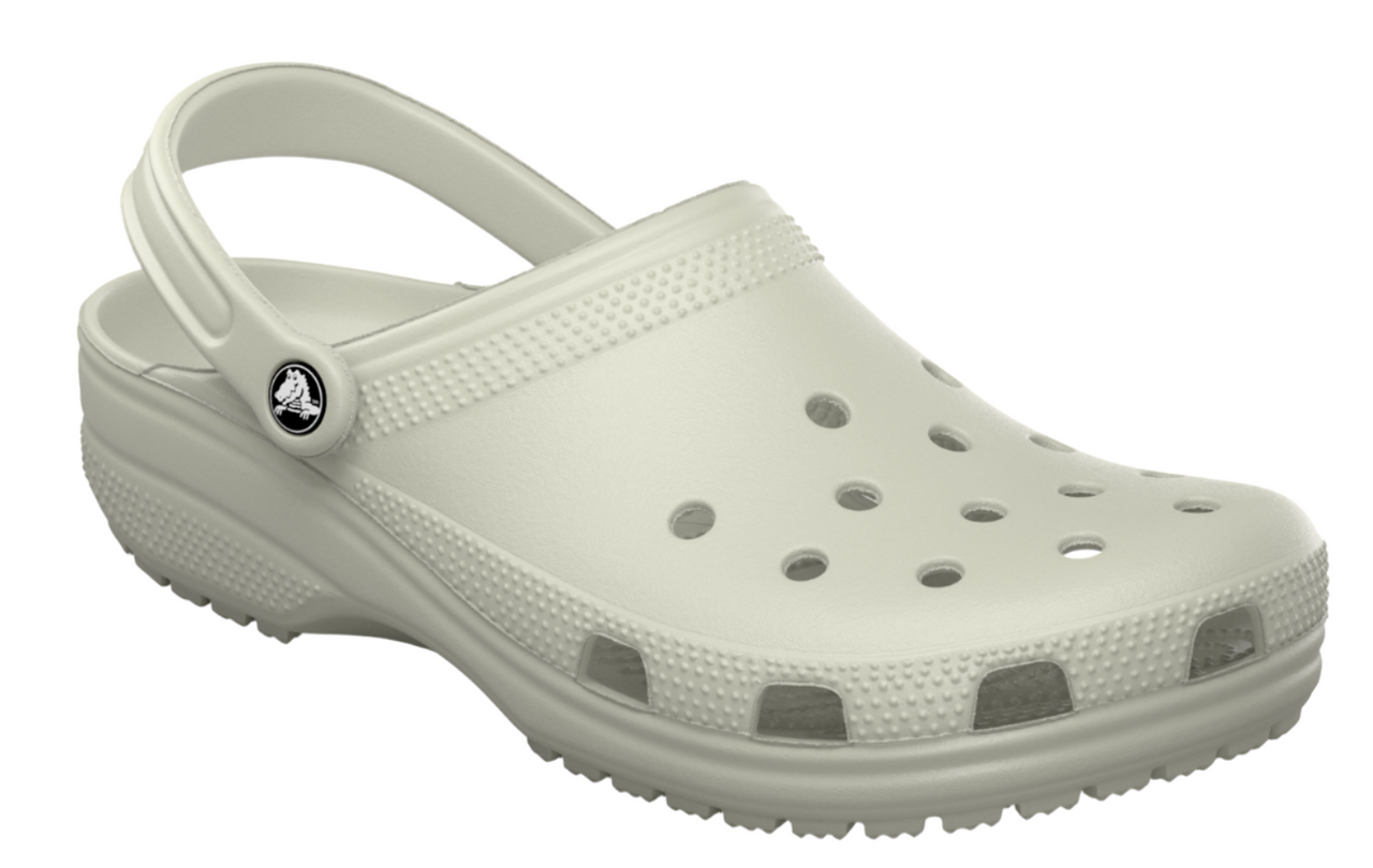 White clog shoe with holes on top and pivoting heel strap.