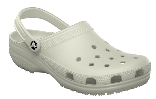 White clog shoe with holes on top and pivoting heel strap.