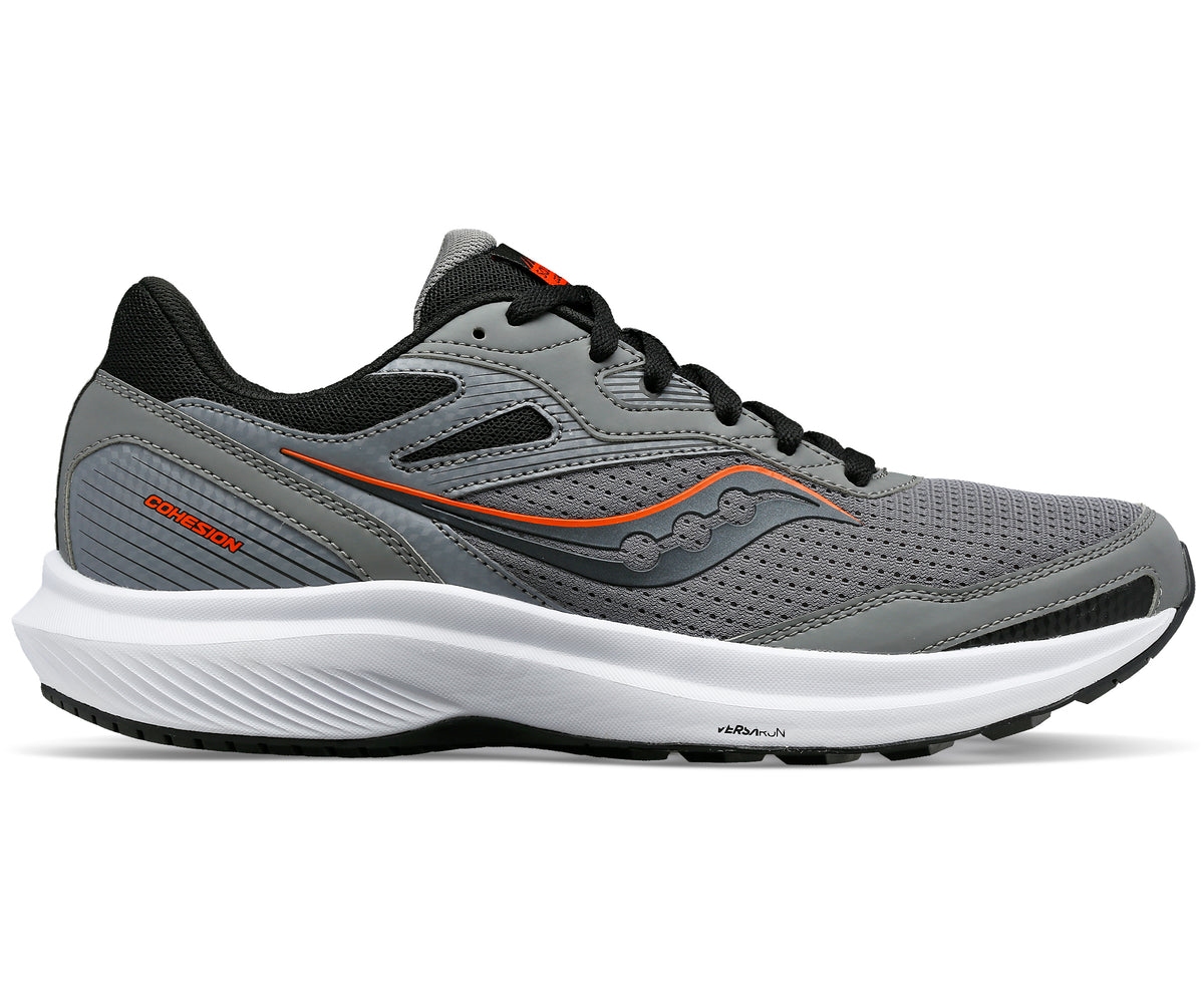 A gray running shoe with black laces and orange detailing on a white sole.