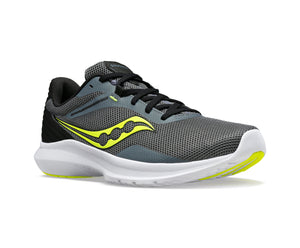 Gray athletic shoe with yellow logo, black laces, white sole, and black heel.