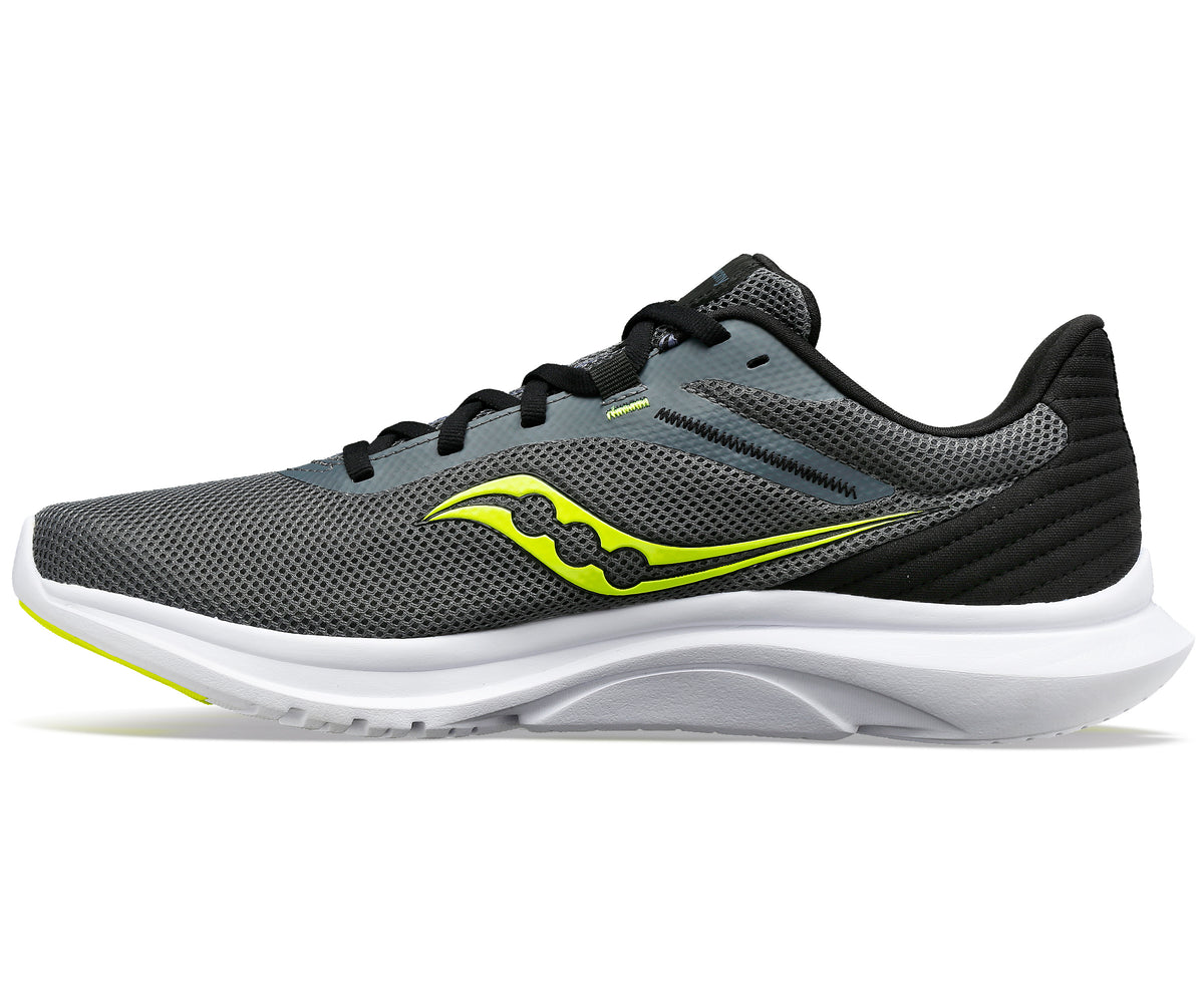 Grey running shoe with yellow logo and white sole