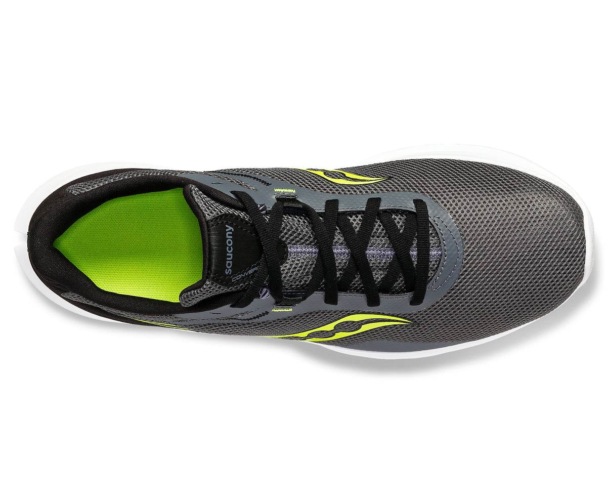 Top-down view of a gray running shoe with black laces and yellow accents.