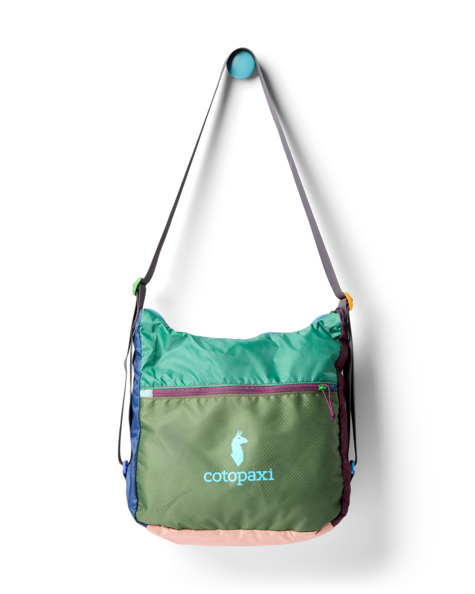 Green, brown, and blue multi-paneled crossbody bag with logo visible on the front.