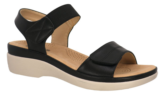 Black sandal with wedge heel and adjustable velcro straps.