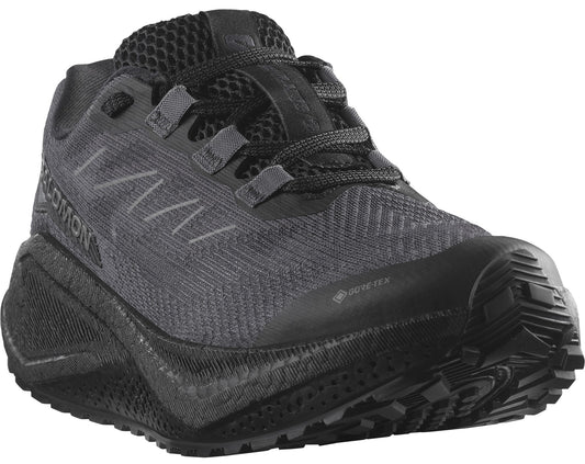 A low-profile running shoe in dark gray with a thick, patterned sole and the word "SALOMON" visible on the side.