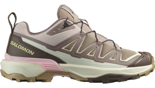A trail running shoe in shades of brown and pink with a quick lacing system and the word SALOMON on the side.