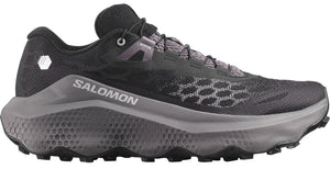 Trail running shoe with a black mesh upper, a grey honeycomb pattern on the midsole and toebox, visible SALOMON text on the side, and black laces.