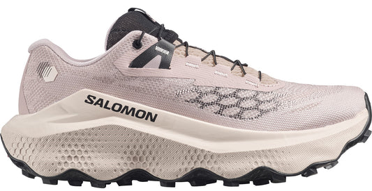 Tan colored athletic shoe with black laces and white midsole with visible logo.