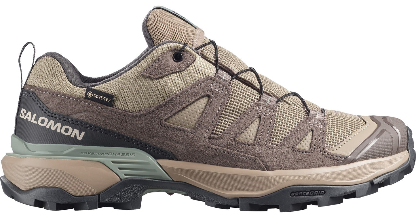 Low-top hiking shoe, tan with brown suede panels and black accents, visible 'SALOMON' logo, 'GORE-TEX' tag.