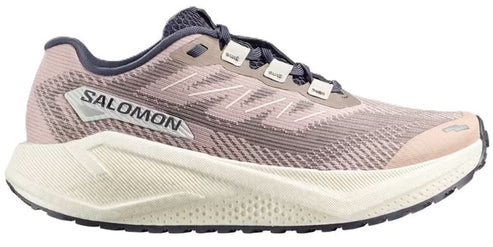 Running shoe with a light pink and gray upper, thick white midsole, black outsole, and the text "SALOMON" visible near the heel.