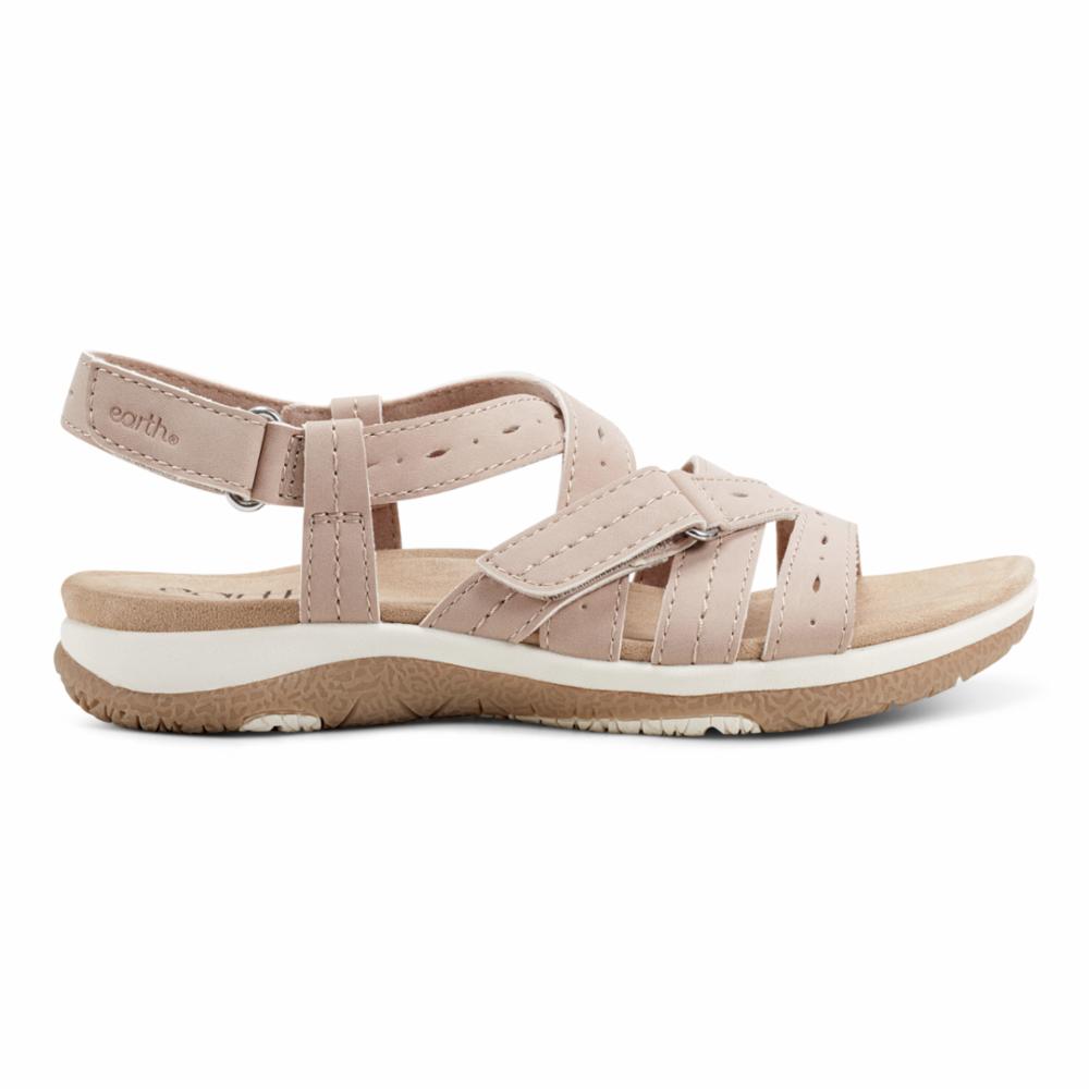 A beige sandal with adjustable straps, featuring a white midsole and a brown outsole.