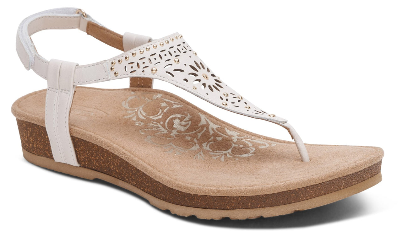 White sandal with t-strap and ankle strap, low wedge heel, perforated design on the upper.