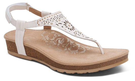 White sandal with t-strap and ankle strap, low wedge heel, perforated design on the upper.