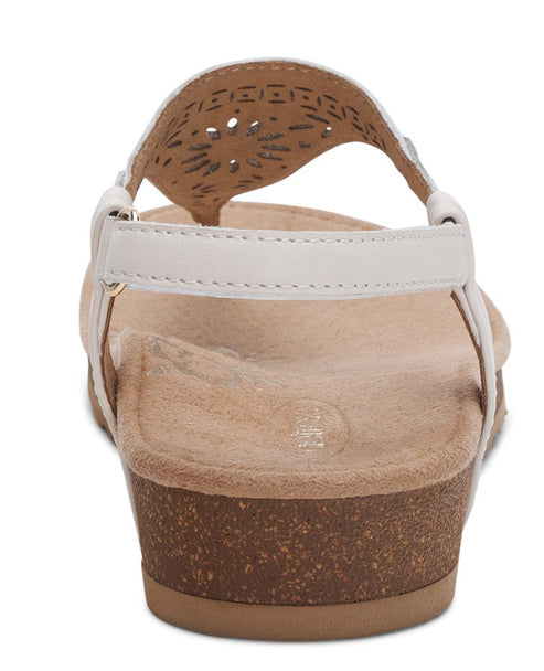 Back view of a women's white sandal with a thong strap and low wedge heel.