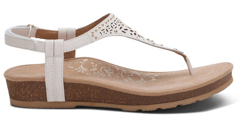 A white sandal with a t-strap and ankle strap.