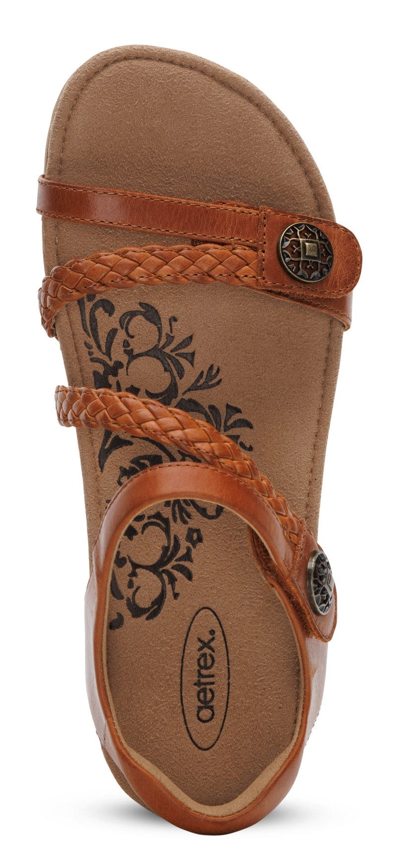 A brown sandal with braided straps and round metal details.