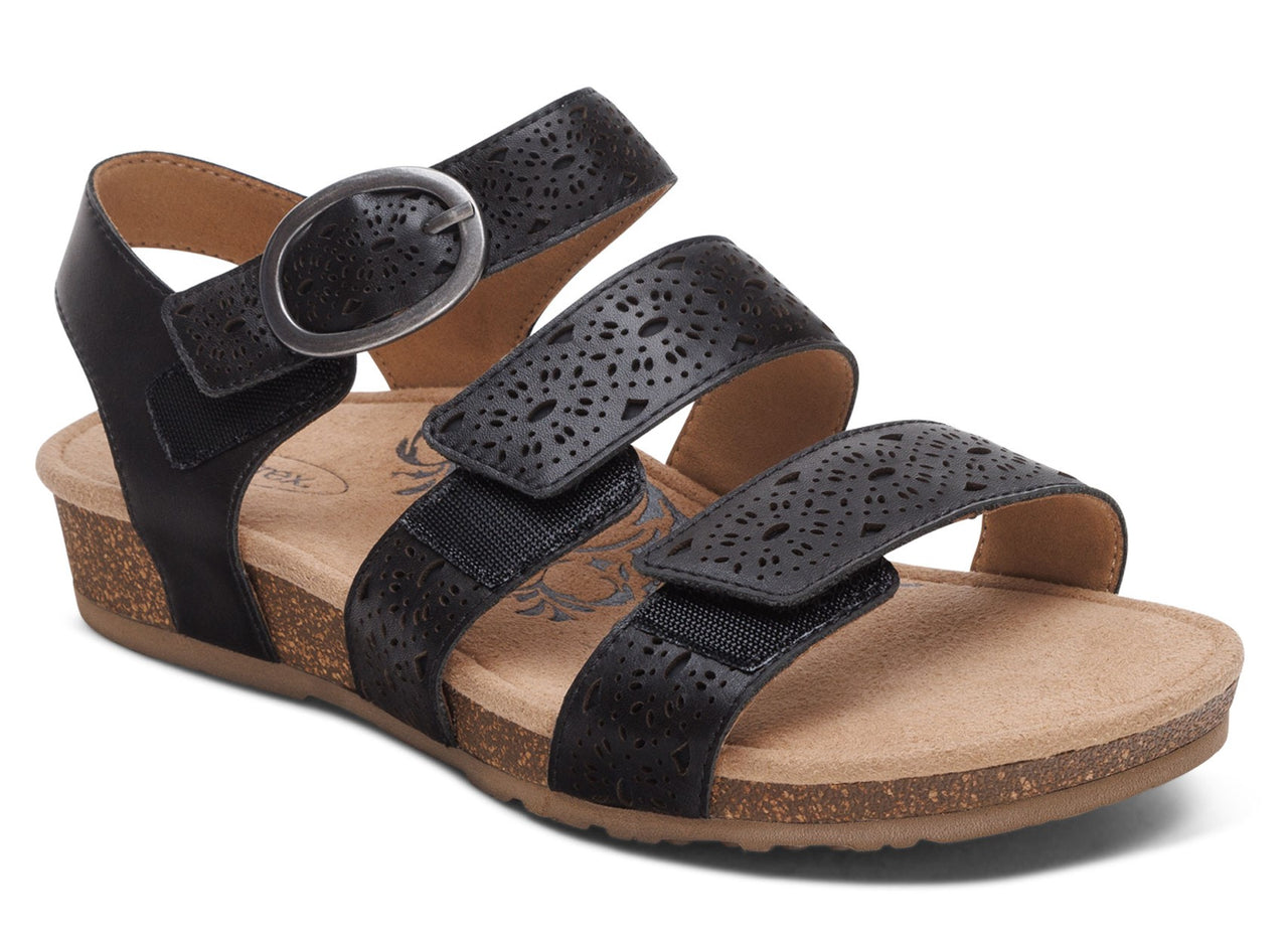 Black sandal with three straps, buckle and laser cut designs.
