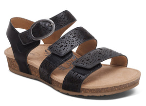 Black sandal with three straps, buckle and laser cut designs.