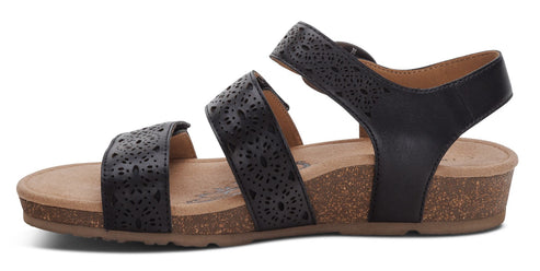 Black sandal with patterned straps and a cork sole.