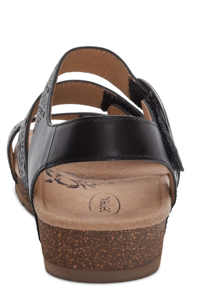 Black sandal with cork sole, featuring straps with floral designs.