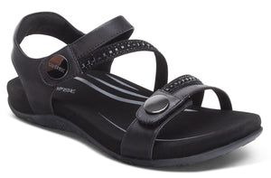 Black sandal with adjustable straps and decorative embellishments.