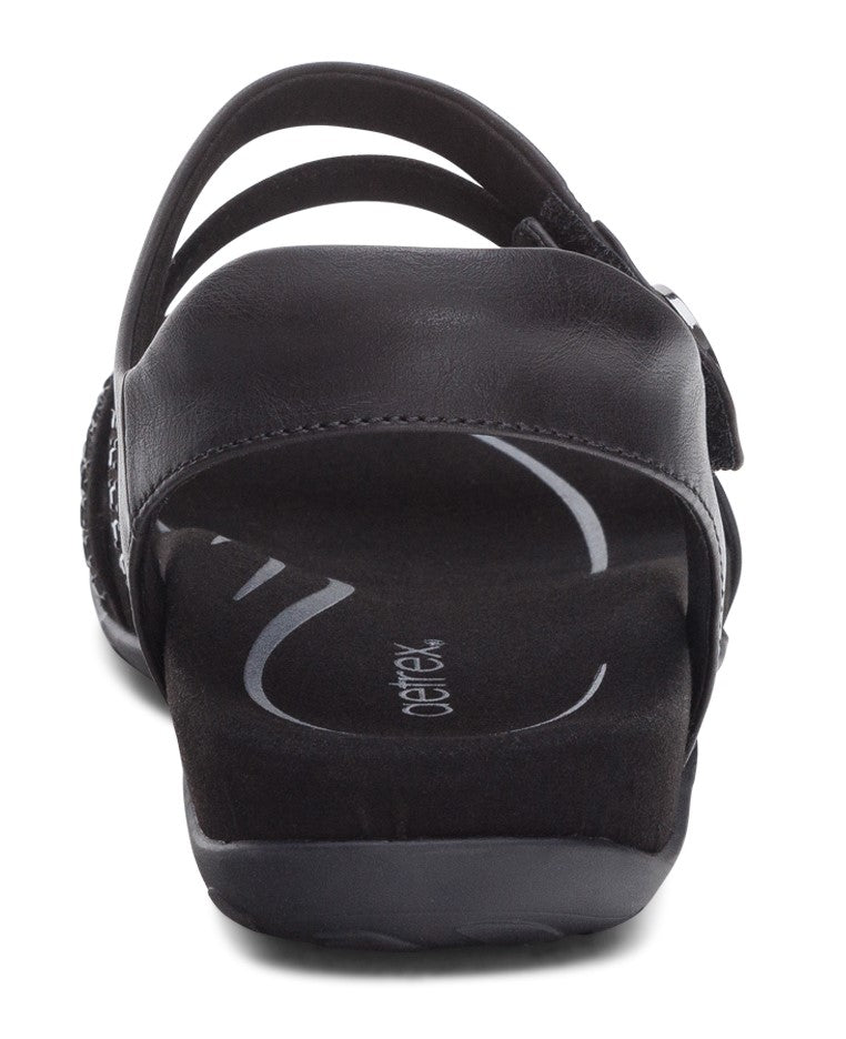 View from the back of a black sandal with multiple straps and an adjustable velcro strap.