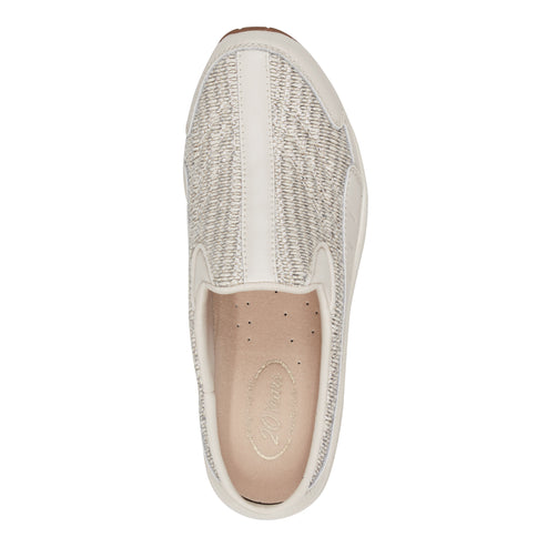 Top-down view of an off-white slip-on shoe with a textured upper.