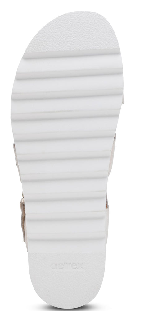 A sandal with a thick, white sole.