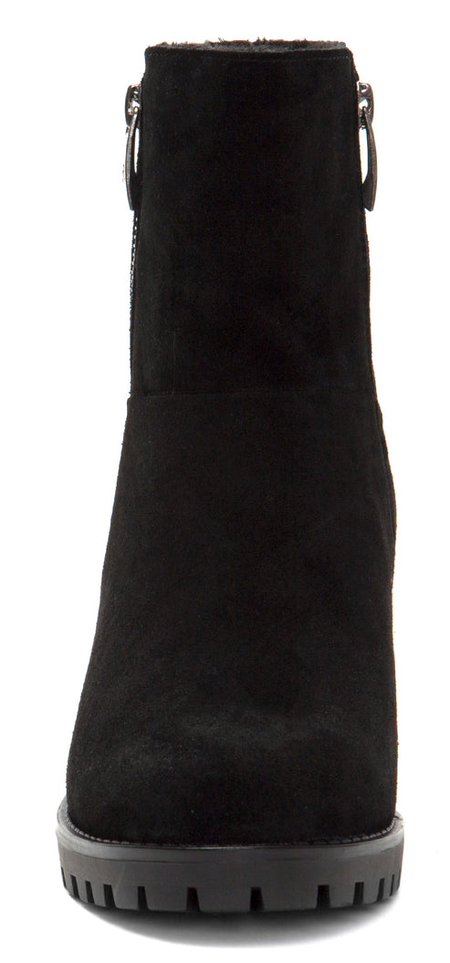 A front view of a black heeled boot with a thick lug sole.