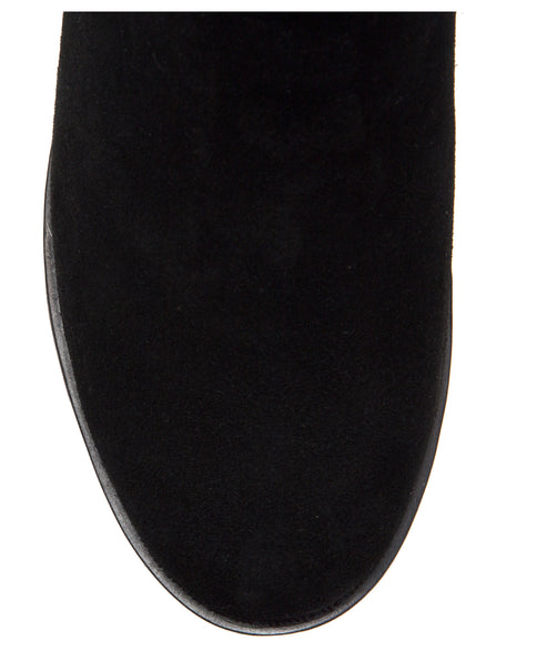 Close-up of black suede boot toe.