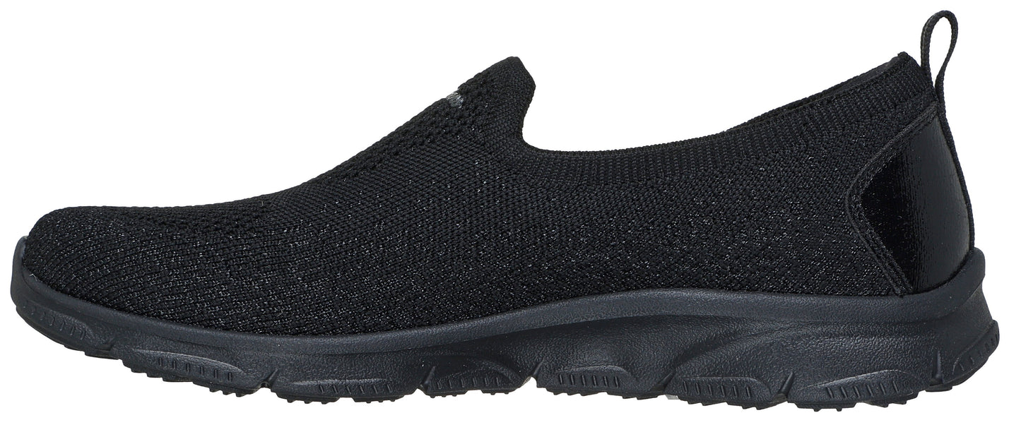 A black slip-on shoe with a knitted upper and black sole.