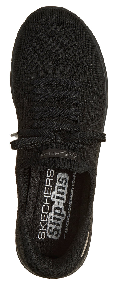 A black shoe with visible text "SKECHERS Slip-ins AIR-COOLED MEMORY FOAM".