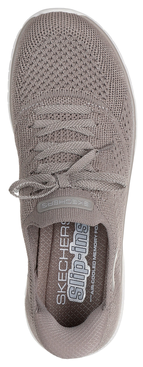 A taupe-colored slip-on shoe with visible laces and "slip-ins" printed on the inner sole.