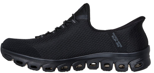 A black slip-on shoe featuring a knit upper, a decorative lace-up design, and a sculpted sole with multiple cutouts.