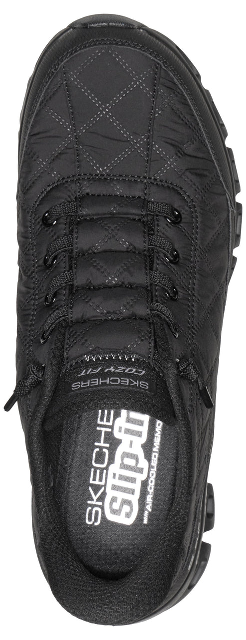 A top-down view of a black, quilted-style slip-on sneaker featuring a bungee lacing system, a padded collar, and visible branding that reads SKECHERS SLIP-INS and COZY FIT.