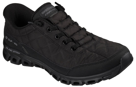 A black Skechers Glide-Step Cozy Fit sneaker with a quilted upper, lace-up front, and a thick, hollowed-out black rubber sole.