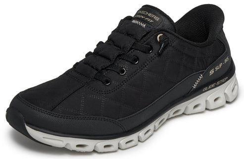 A black sneaker with a white midsole and a patterned upper.