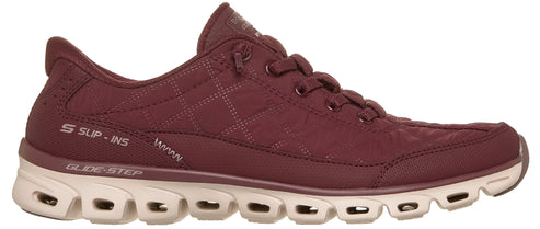 A maroon quilted Skechers Slip-ins Glide-Step sneaker with a beige textured midsole and laces.