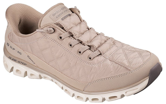 A beige, quilted-texture, low-top sneaker featuring a lace-up front, a padded collar, a thick, white, hollow-out patterned sole, and the visible text "SKECHERS COZY FIT" on the tongue and "SUP-INS GLIDE-STEP" on the heel.