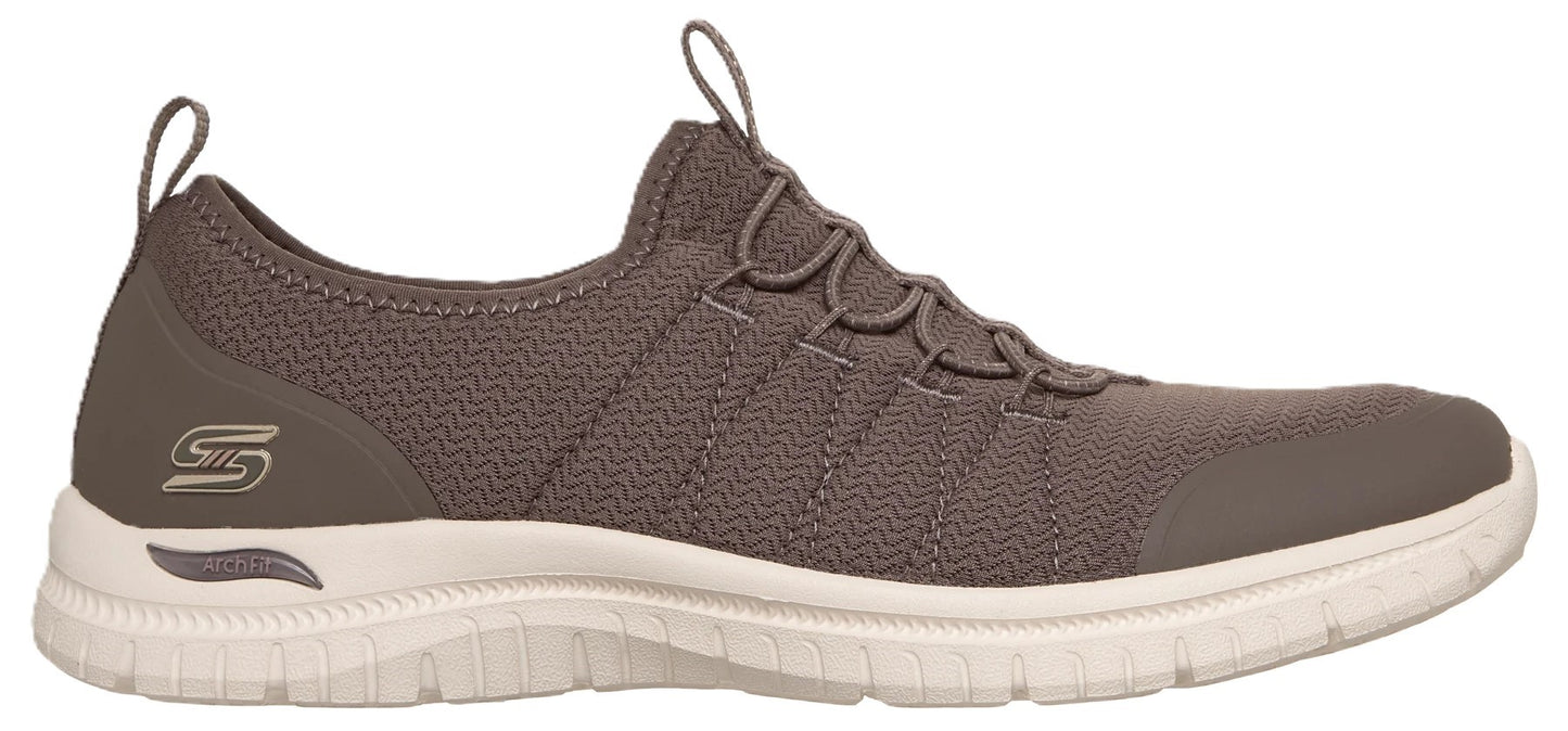 A taupe-colored, slip-on sneaker with a knit upper, elastic laces, and a thick, off-white midsole featuring arch support cushioning, with a visible logo on the heel.