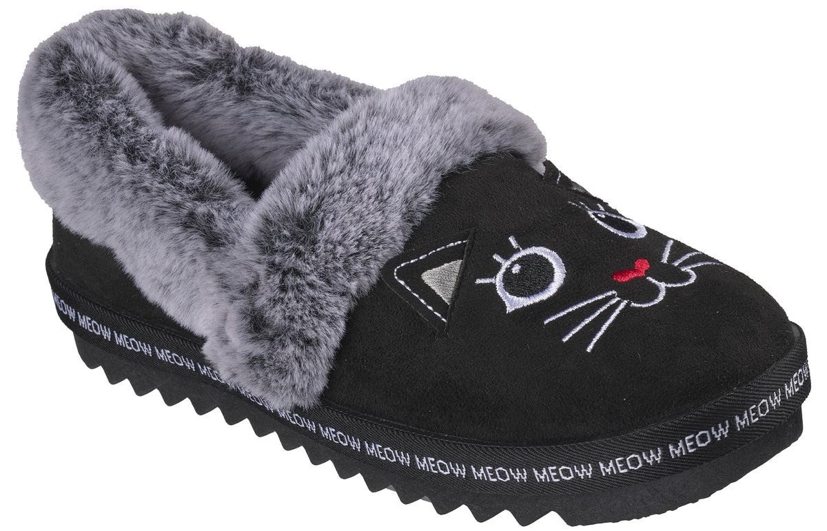 A black faux-suede slipper with a grey faux-fur trim, featuring an embroidered cat face on the front and 'MEOW' repeated in white text along the ridged black rubber sole.
