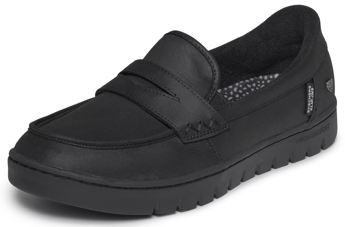 A black penny loafer shoe with a chunky, serrated sole, showing a soft leather-like upper with a classic strap across the top and a small black fabric tag on the side.