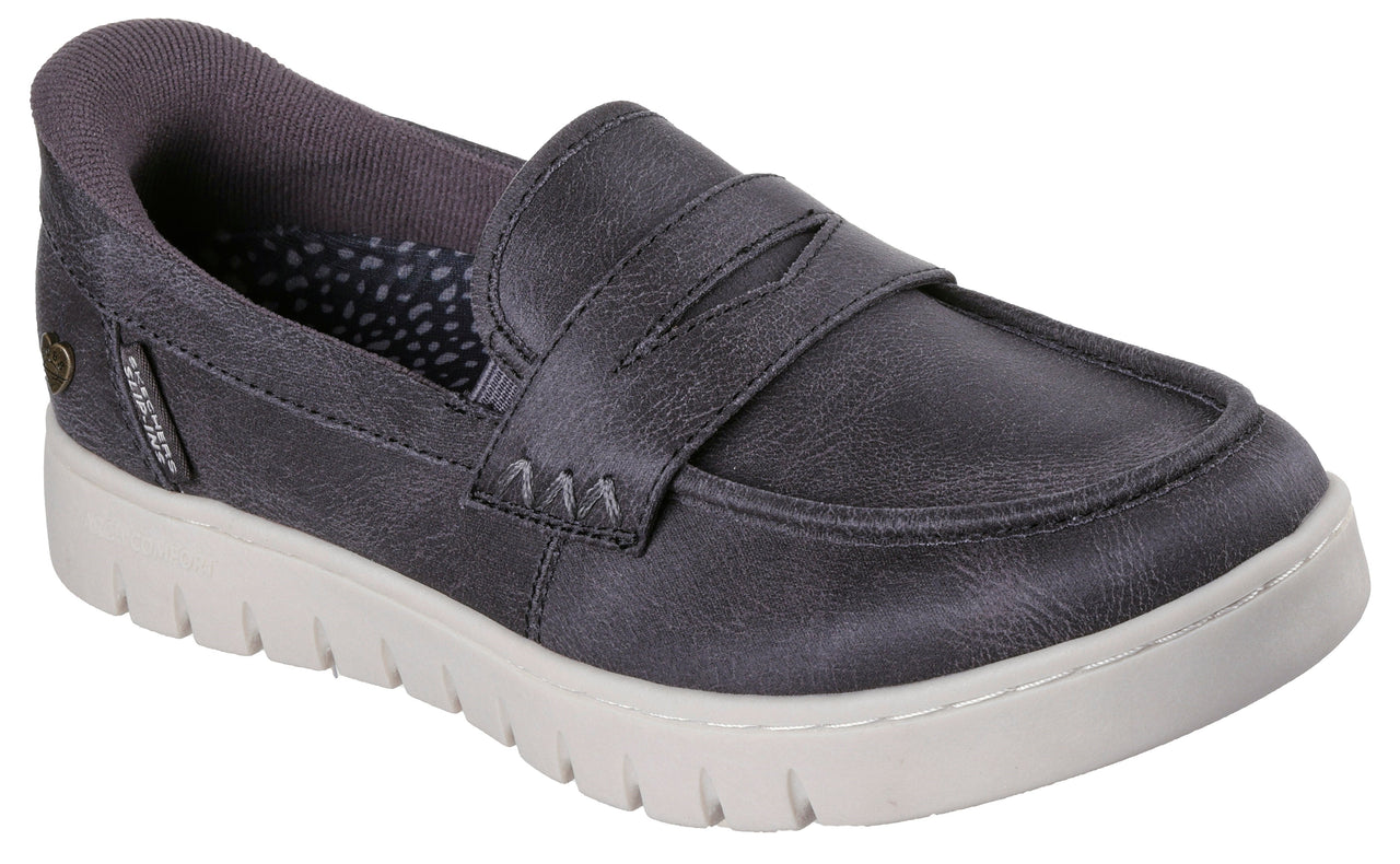 A slip-on charcoal grey loafer with a textured faux leather upper and a chunky white platform sole.